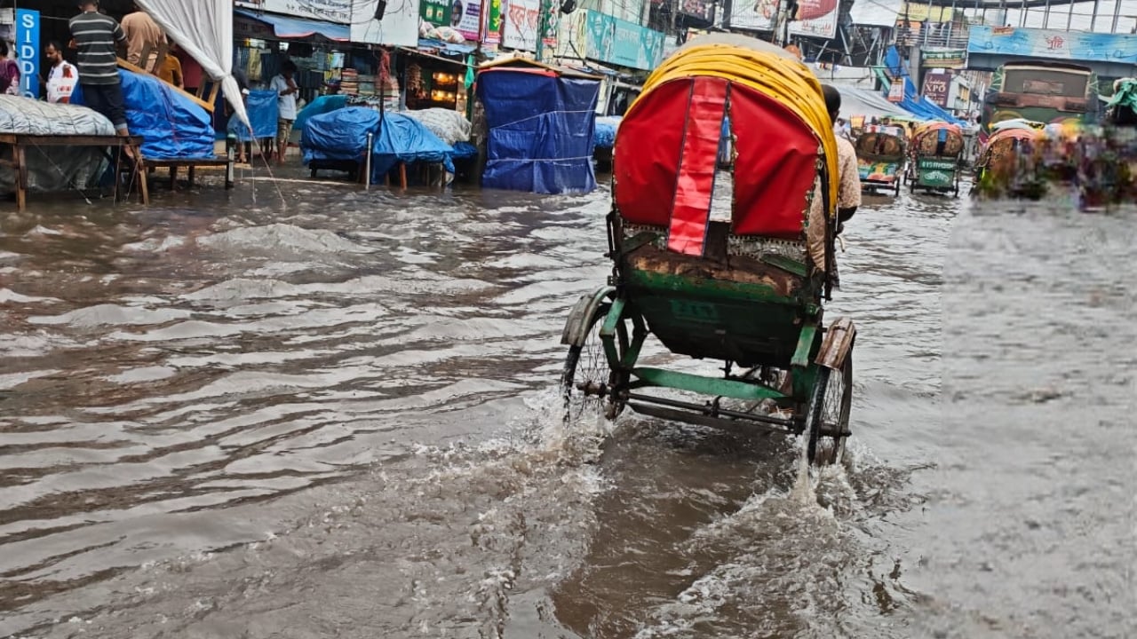 রিকশা না চললে ঘুরবে না সংসারের চাকা। তাই জমে থাকা পানিতেও ঘোরাতে হচ্ছে রিকশার চাকা