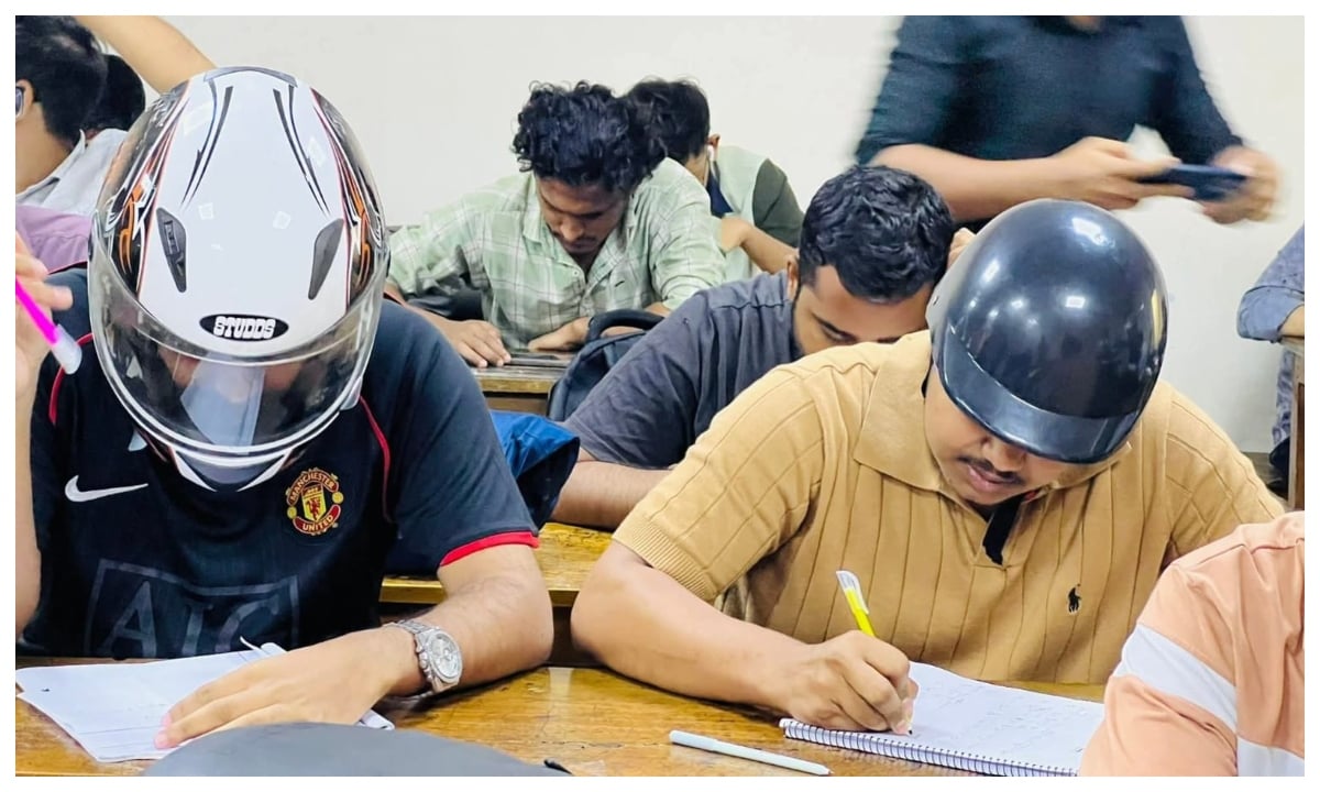 মাথায় হেলমেট পরে ক্লাসে দুই শিক্ষার্থী