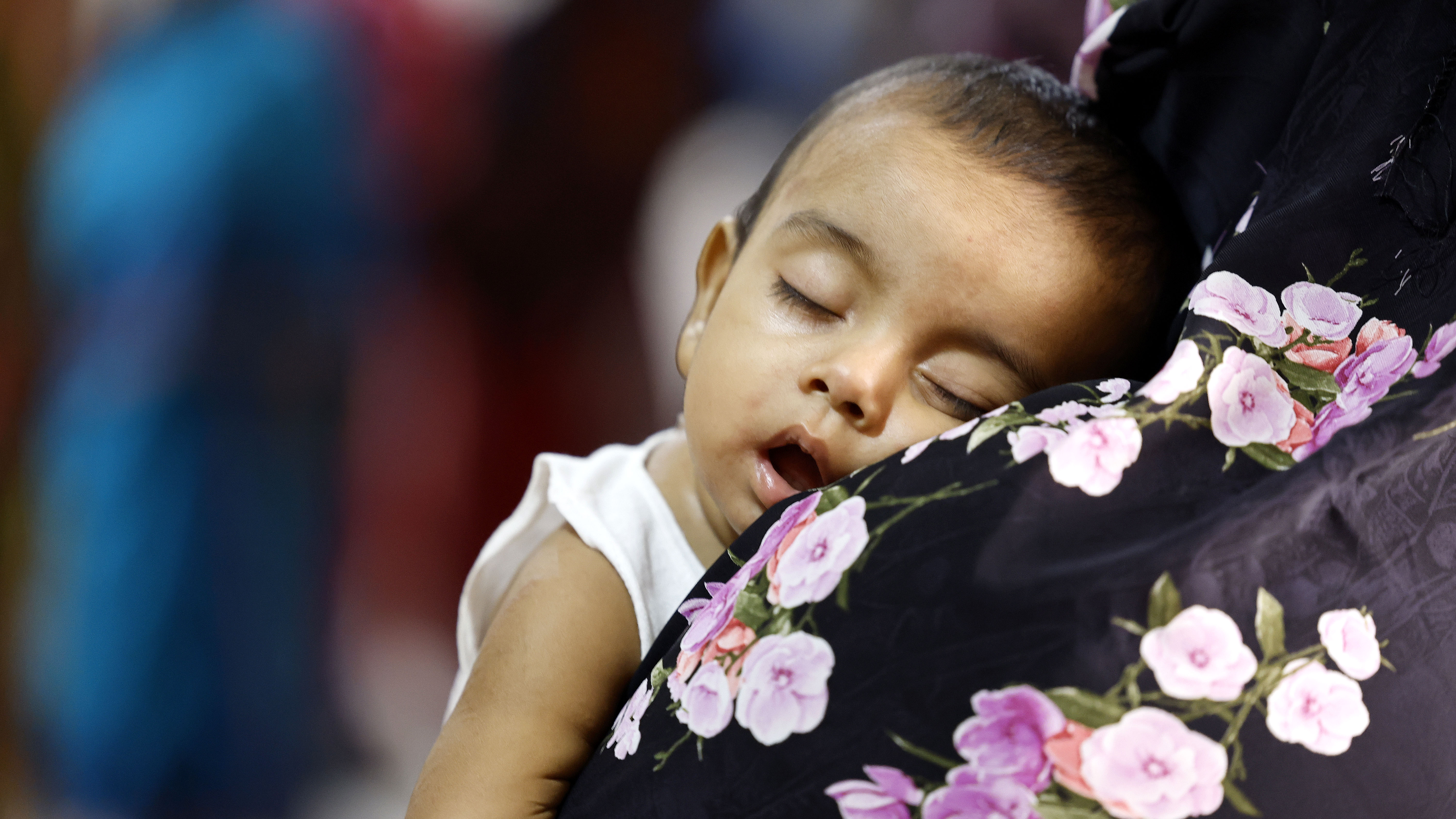 মায়ের কোলে ঘুমিয়ে হাম আক্রান্ত এক শিশু